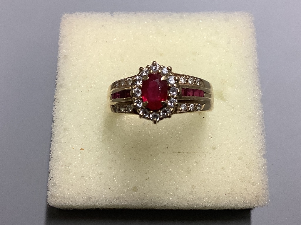A modern 14 K yellow metal, ruby and diamond cluster ring, size M, gross 3.9 g.
